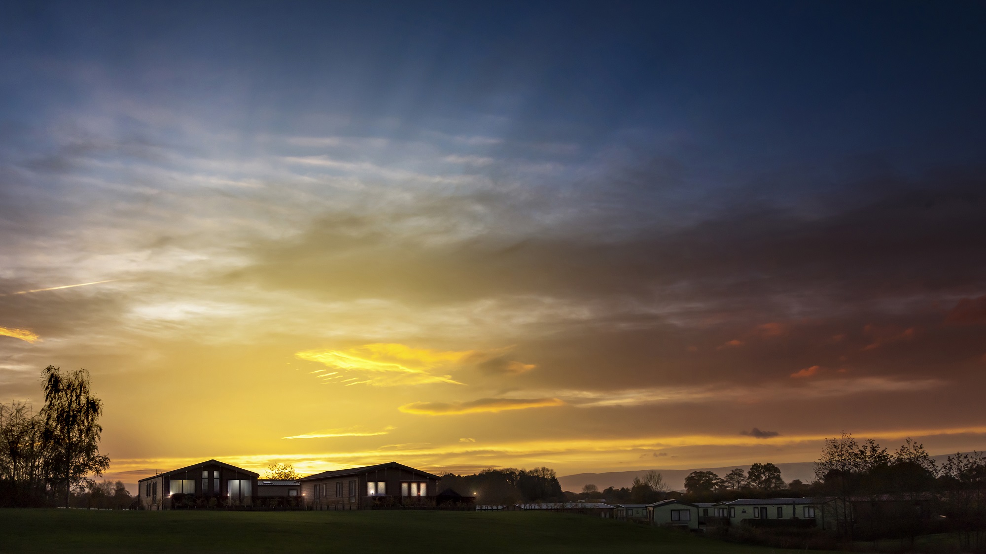 holiday lodge exterior with countryside views - pet friendly holiday parks UK