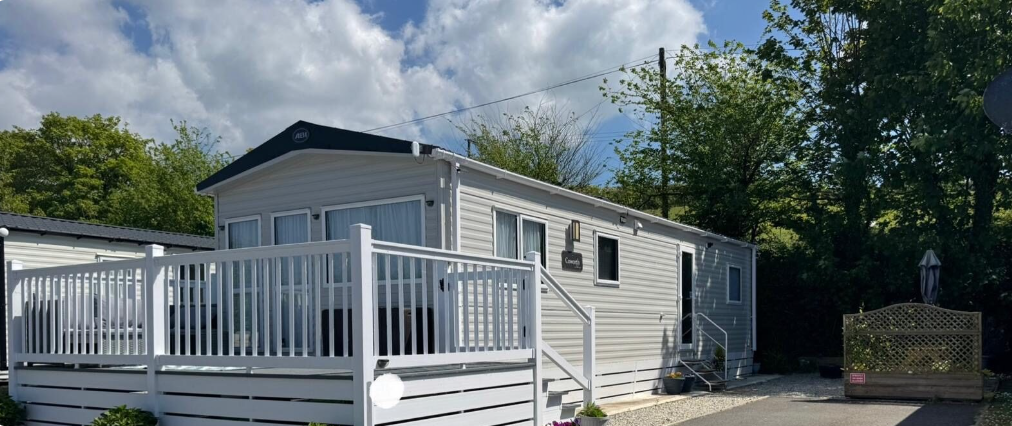Holiday lodge with white decking at a UK holiday park