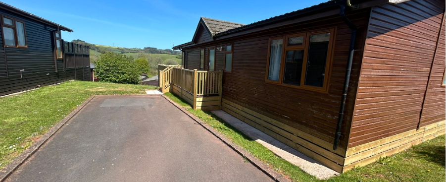 Timber holiday lodge with decking and countryside views on a UK holiday park.